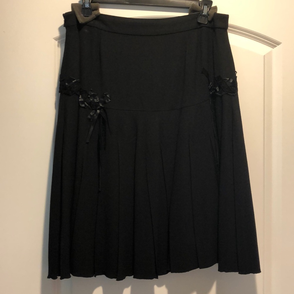 Never worn, pleated skirt with embellishments.